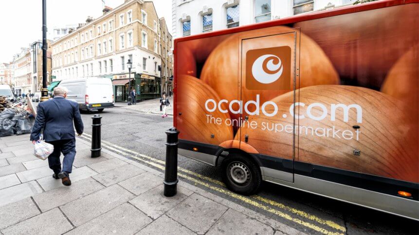 Ocado online store grocery shopping delivery supermarket sign on truck with red orange color in Covent Garden near SoHo
