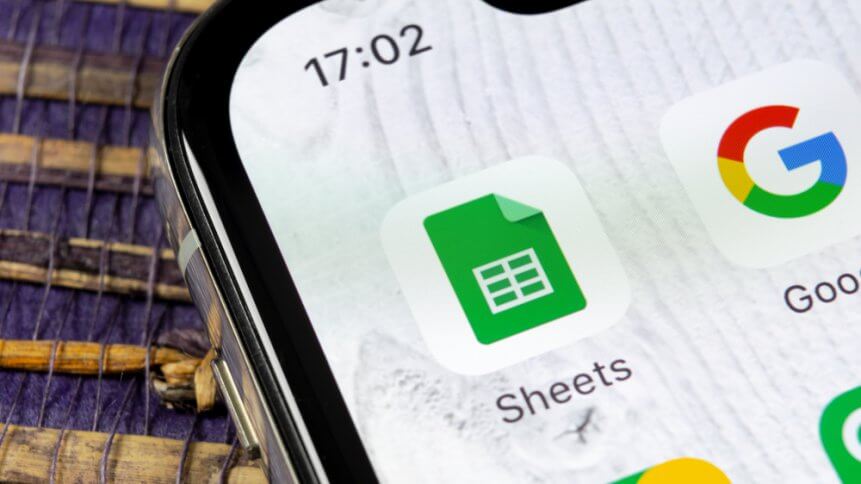 Google Sheets icon on Apple iPhone X smartphone screen close-up. Google sheets icon