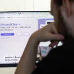 A man stares at Microsoft Teams on his computer.